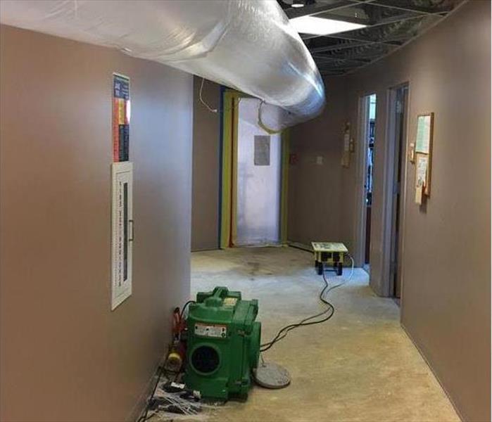 overhead flex conduit, air scrubbers in carpeted hallway